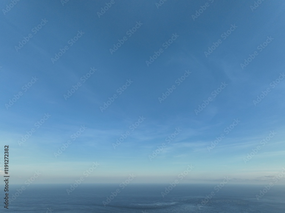 Vast Blue Sky: A breathtaking panorama of a serene blue sky stretching to the horizon. The gentle sweep of clouds adds subtle texture to the endless expanse. Vast Blue Sky: A breathtaking panorama of a serene blue sky stretching to the horizon. The gentle sweep of clouds adds subtle texture to the endless expanse.