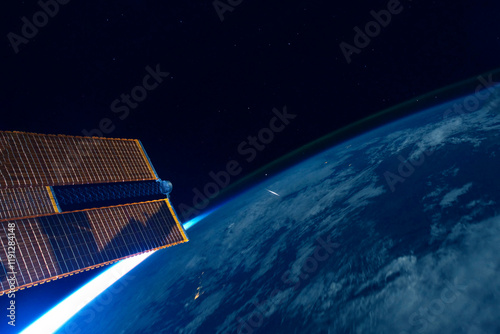 Fototapeta Naklejka Na Ścianę i Meble -  A space satellite above the Earth's surface. Elements of this image furnished by NASA