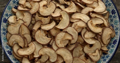 Homemade dried sliced Asian pears on a plate. Table spin.  photo