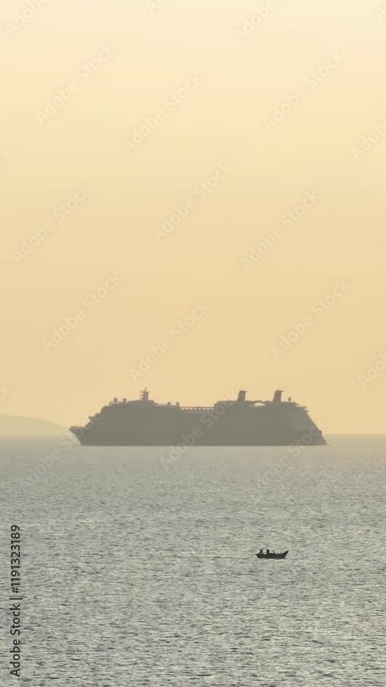 Beautiful sunset view of a cruise ship on the horizon over calm waters. Vertical, vertical video Beautiful sunset view of a cruise ship on the horizon over calm waters. Vertical, vertical video