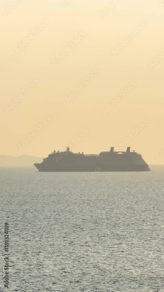 Cruise ship sailing across calm waters during a tranquil sunset. Vertical, vertical video Cruise ship sailing across calm waters during a tranquil sunset. Vertical, vertical video