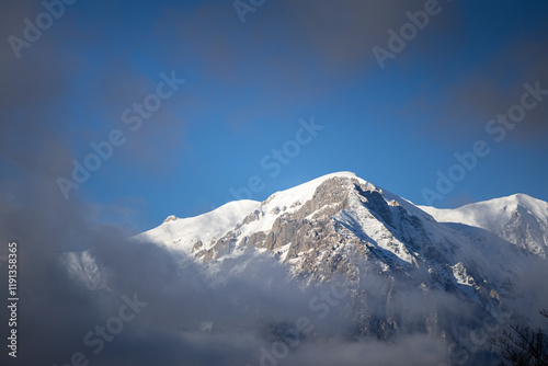 Obraz na płótnie Winter in the Romanian mountains. Beautiful view through the clouds to Bucegi Mountains, next to Busteni, Azuga, Sinaia and Predeal mountain ski resorts. Travel and hike to Romania. w salonie