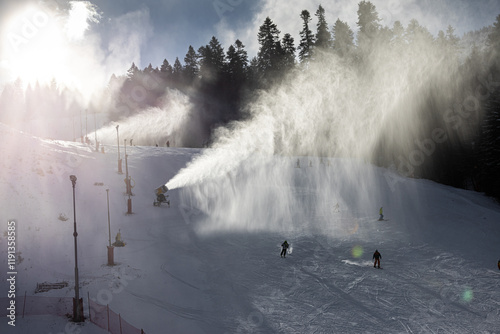 Obraz na płótnie Snow making in a mountain resort. Beautiful view with snow cannons powered on to create snow from water and to keep the slopes available for tourists. w salonie