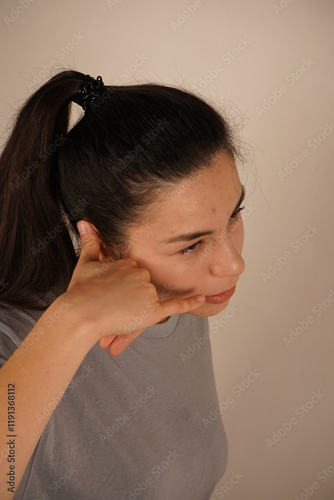 A hand raised to the ear mimics a phone call, suggesting connection or communication. This playful gesture embodies a call for attention or interaction. A universal symbol of staying in touch. A hand raised to the ear mimics a phone call, suggesting connection or communication. This playful gesture embodies a call for attention or interaction. A universal symbol of staying in touch.
