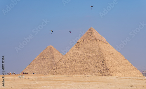 Hang gliders flying down to land beside the pyramid of Khafre and Great Pyramid of Giza