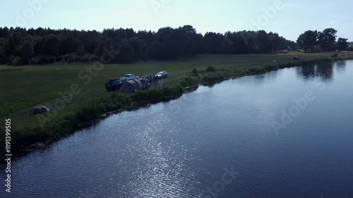  View of a Beautiful  River at Sunset Surrounded by Green Fields Drone Aerial 4K Slow Motion