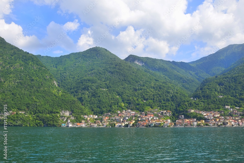 Stunning view of mountains, sky with clouds, village on Lake Como, Italy. Stunning view of mountains, sky with clouds, village on Lake Como, Italy.