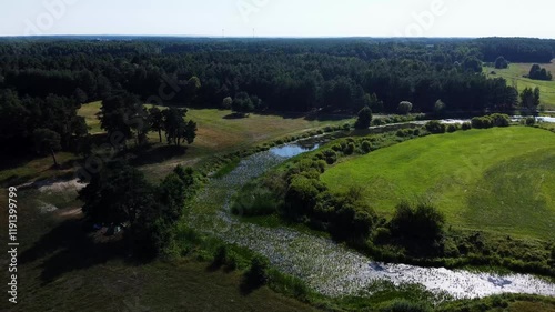 View of a Beautiful  River at Sunset Surrounded by Green Fields Drone Aerial 4K Slow Motion
