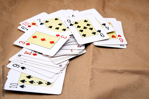 A deck of poker cards spread out on a table.