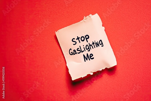 Note on bright red background, urging end to gaslighting behavio photo