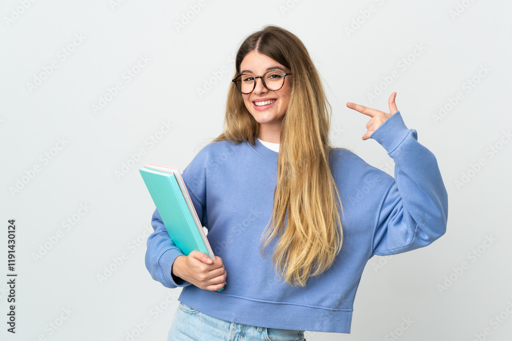 Young blonde student woman isolated on white background giving a thumbs up gesture Young blonde student woman isolated on white background giving a thumbs up gesture