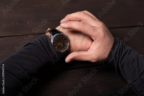 man pointing at hand watch