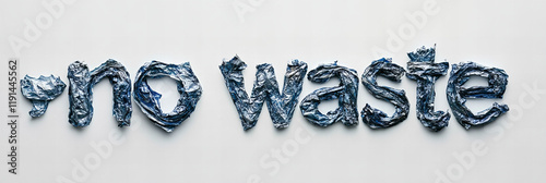 No waste message created with crumpled aluminum foil highlighting environmental awareness in minimalistic design