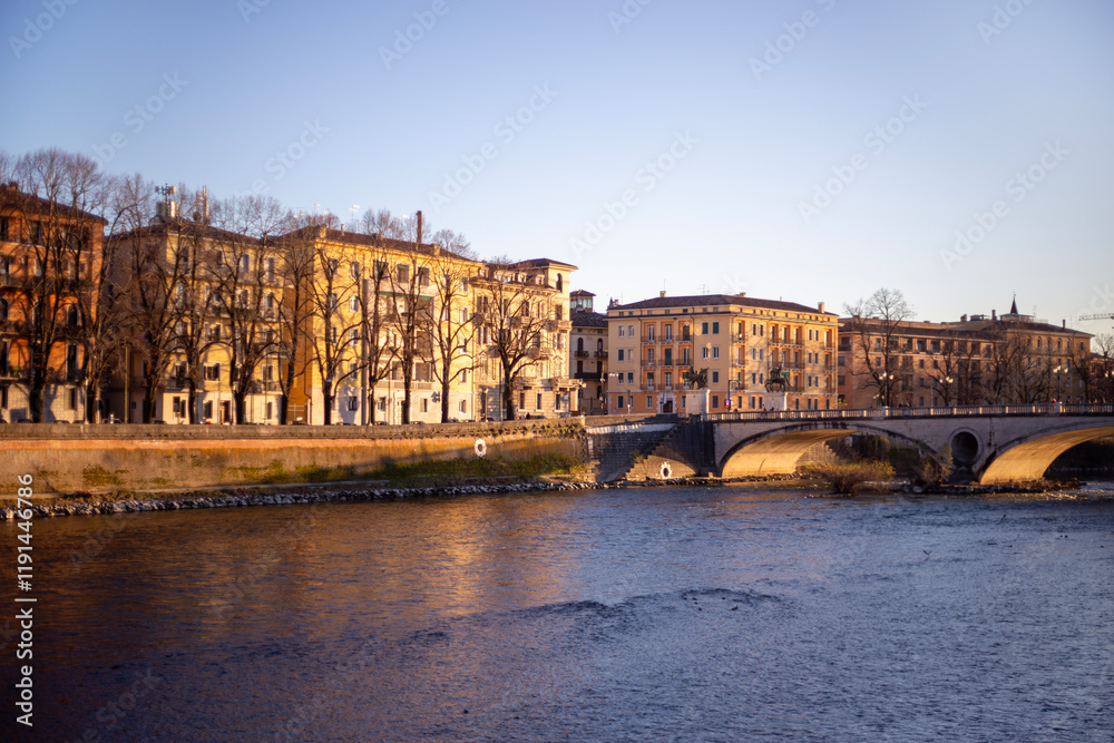 Fototapeta premium Italian city River Adige with bridge and buildings