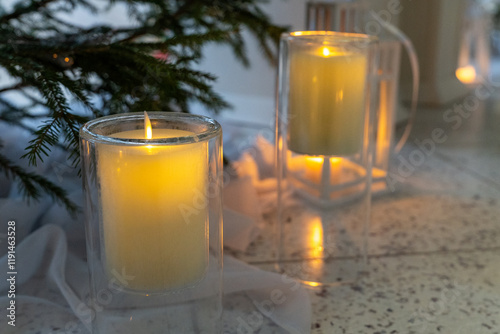 Burning Candles in Glass Holders with Warm Glow. Decorative Candles for Christmas Ambience. photo