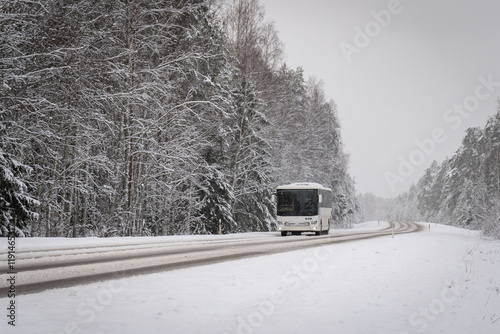 Bus Traveling Through Snowy Winter Road. Rural Winter Journey by Bus. photo