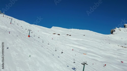 Seceda on the Val Gardena resort presents an awe-inspiring winter spectacle, captured from the air by drone. Its iconic jagged peaks rise dramatically above snow-covered slopes photo