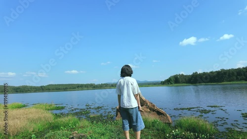 Person on the lake Walking in Front of a Rock