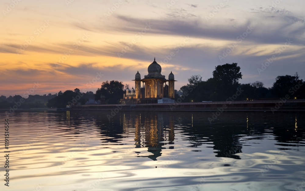 Sunrise reflecting on a lake with a grand mausoleum. Sunrise reflecting on a lake with a grand mausoleum.