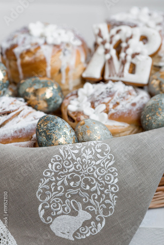 Banner for Orthodox Easter. Easter eggs with gold, Easter cakes and gingerbread in the shape of the letters XB in a woven basket made of vines. photo