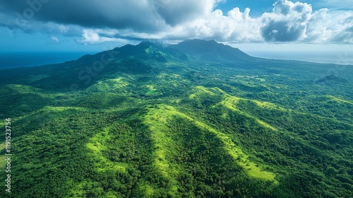 Lush green mountains under dramatic clouds with clear blue sky during midday