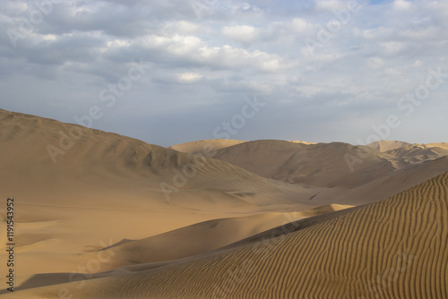 The sand dunes of Huacachina, Peru are a very popular tourist spot, where many try sandboarding or driving dune buggies.