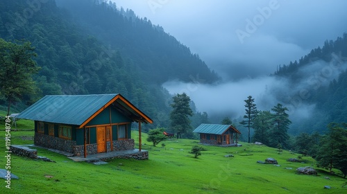 Tranquil cabins in misty mountains under overcast sky during early morning hours