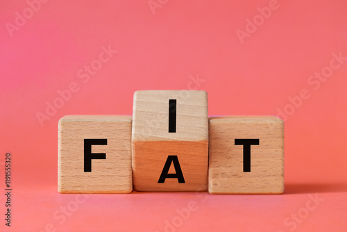 Obraz na płótnie Hand is turning wooden block and changes the word FAT to FIT. Conceptual words. Changing habits. Healthy lifestyle. Losing weight. Copy space w salonie