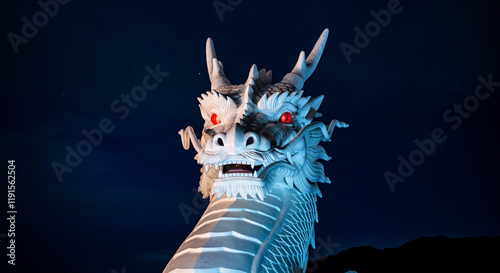 Dragon statue with fierce expression and intricate details at night photo