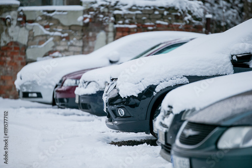 Cars covered in white snow after snow storm in car parking. after holiday in early morning before going to work