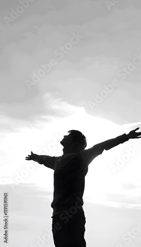 Silhouette of young freeman wearing sweater open both arms
