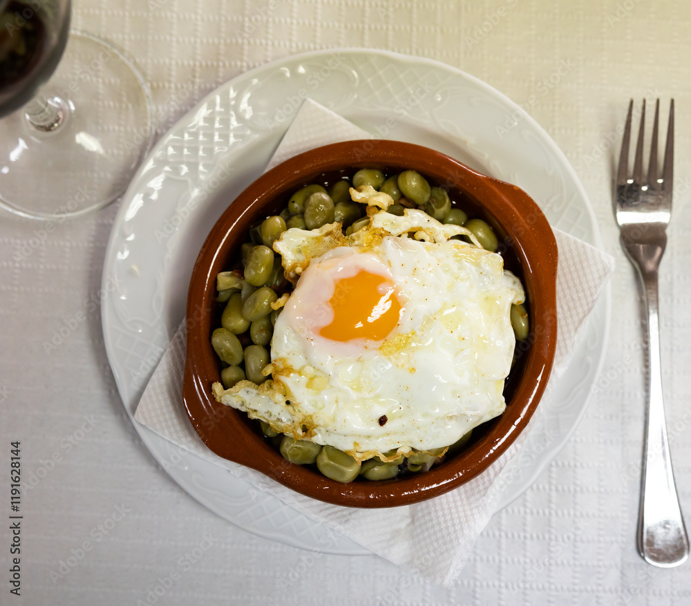 Appetizing fried eggs with beans and ham served for breakfast Appetizing fried eggs with beans and ham served for breakfast