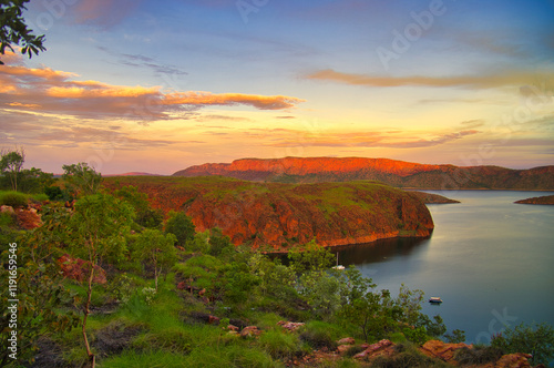 Spectacular sunset at Lake Argyle, a man-made reservoir in the Ord River, and the surrounding red rocks in the outback near the East Kimberley town of Kununurra, Western Australia

