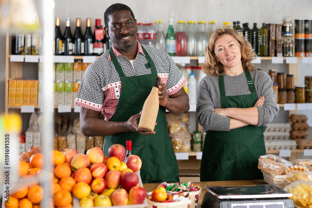 Positive female and male sellers offers choice of various natural food in a grocery supermarket Positive female and male sellers offers choice of various natural food in a grocery supermarket