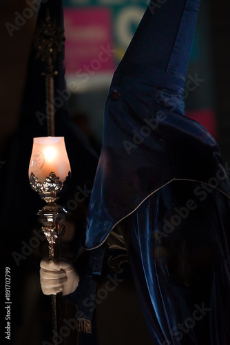 Nazarenes in blue, with a lantern and a candle, to illuminate the streets of Cartagena, in the Holy Monday procession