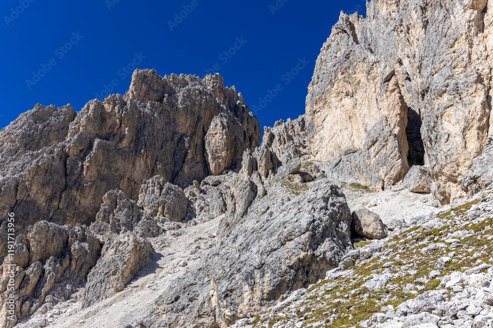 Via ferrata in the Dolomites. Equipped with bridge and steel cable hiking and climbing path in the high rocky mountains in Dolomiti Alps. Historical and extreme passages between the mountain cliffs an Via ferrata in the Dolomites. Equipped with bridge and steel cable hiking and climbing path in the high rocky mountains in Dolomiti Alps. Historical and extreme passages between the mountain cliffs an