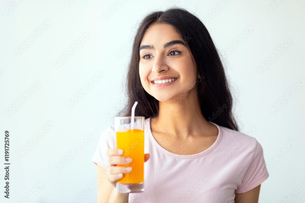 Cheerful Indian woman holding glass of refreshing fruit juice indoors, copy space. Joyful Hindu lady enjoying her yummy drink. Summer detox, wellness, dieting concept Cheerful Indian woman holding glass of refreshing fruit juice indoors, copy space. Joyful Hindu lady enjoying her yummy drink. Summer detox, wellness, dieting concept