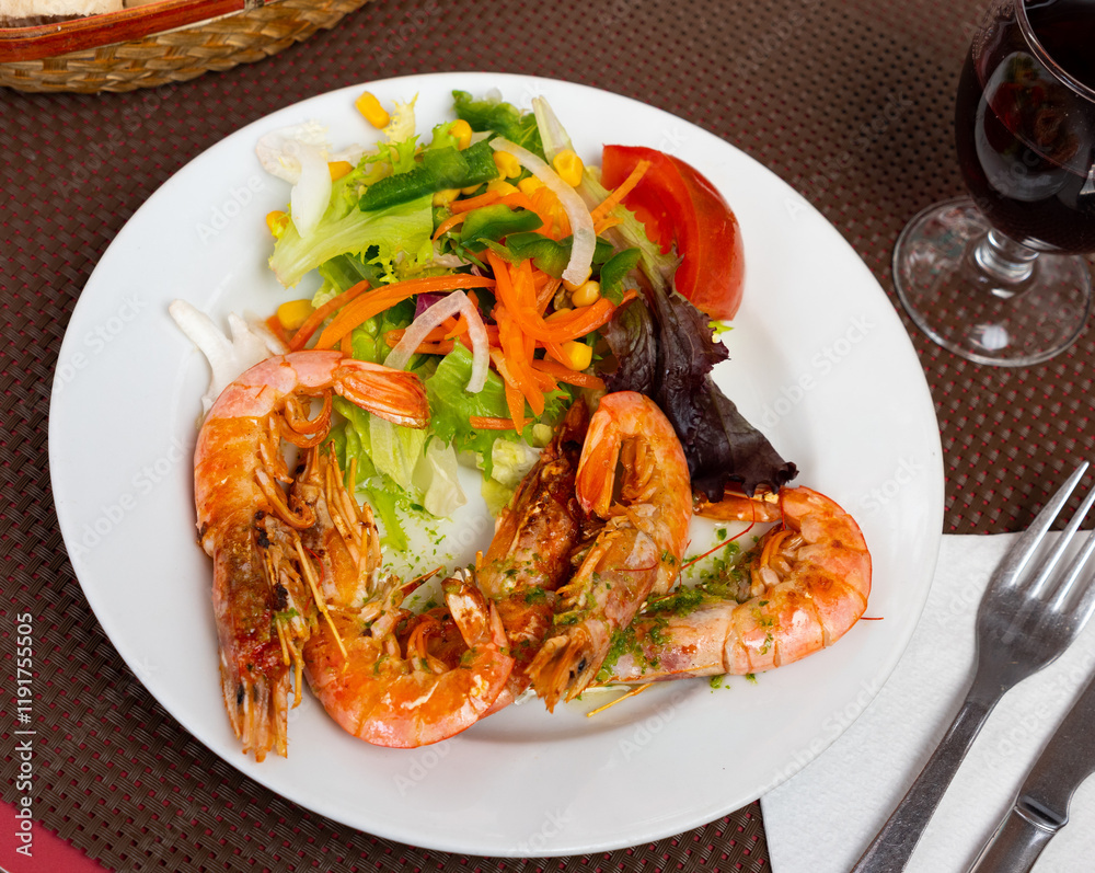 Appetizing shrimp with fresh vegetable salad served on platter Appetizing shrimp with fresh vegetable salad served on platter