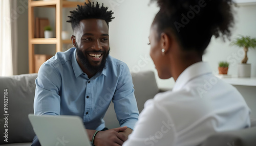 man and woman engage in friendly conversation, sharing smiles and ideas in cozy setting. Their connection reflects warmth and collaboration