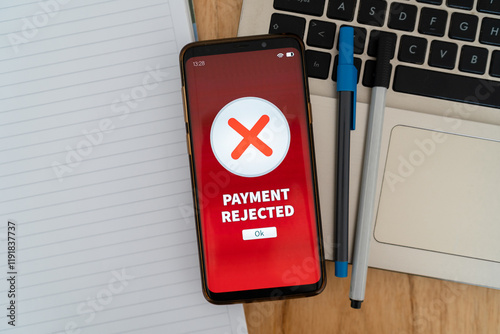 Payment rejected notification on smartphone over the work desk.