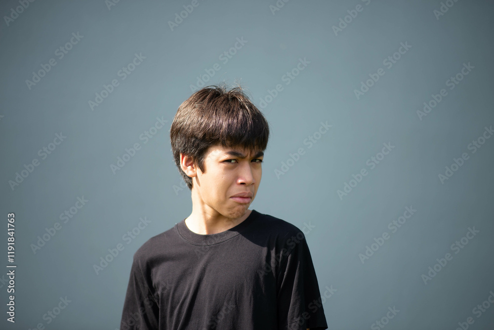 Fototapeta premium Teenage Boy's Expressions Collage: A captivating grid showcases a young Asian boy's diverse facial expressions, capturing a range of emotions from joy to contemplation.