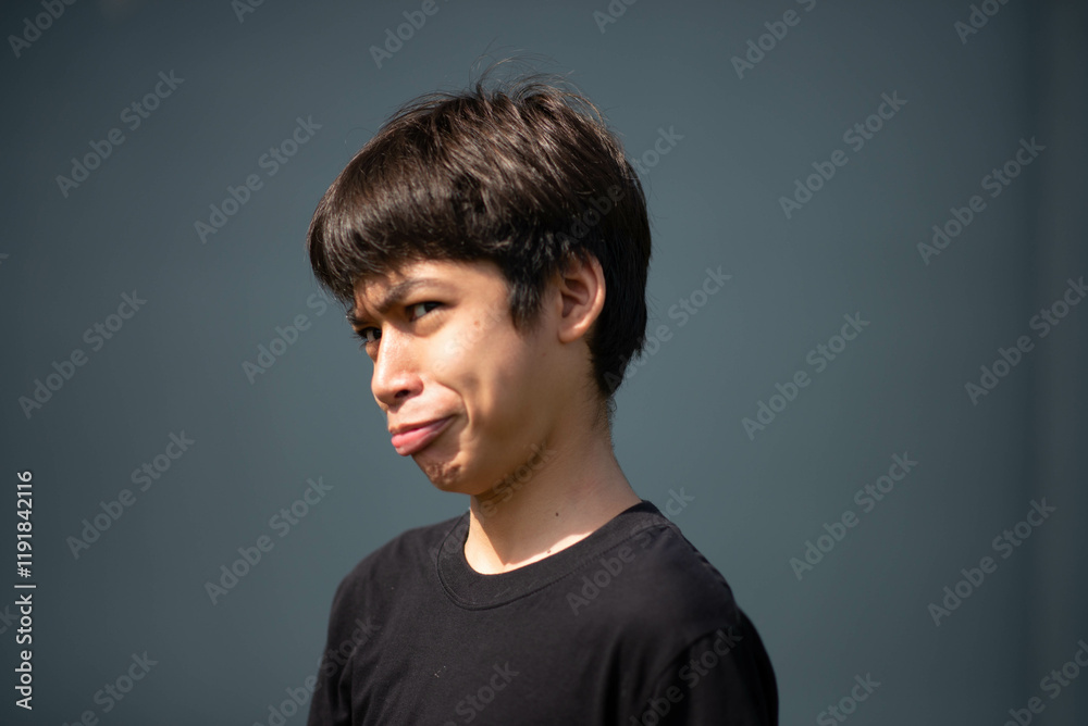 Teenage Boy's Expressions Collage: A captivating grid showcases a young Asian boy's diverse facial expressions, capturing a range of emotions from joy to contemplation. Teenage Boy's Expressions Collage: A captivating grid showcases a young Asian boy's diverse facial expressions, capturing a range of emotions from joy to contemplation.