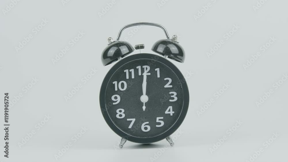 Close-Up of Black Analog Alarm Clock Ringing at Twelve AM or PM – Classic Timepiece Alarm Sound on White Background for Time, Routine, and Morning Concepts Close-Up of Black Analog Alarm Clock Ringing at Twelve AM or PM – Classic Timepiece Alarm Sound on White Background for Time, Routine, and Morning Concepts