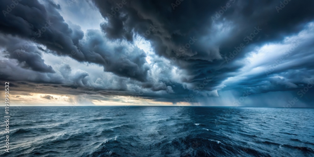 Fototapeta premium Dark grey stormy sky with heavy clouds and strong winds over the vast blue ocean, sea, stormy weather