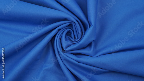 Close-up of blue cotton fabric showing a detailed woven texture, soft natural fibers, and a smooth textile surface perfect for design or background use.