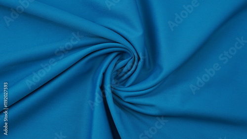 Close-up of blue cotton fabric showing a detailed woven texture, soft natural fibers, and a smooth textile surface perfect for design or background use.