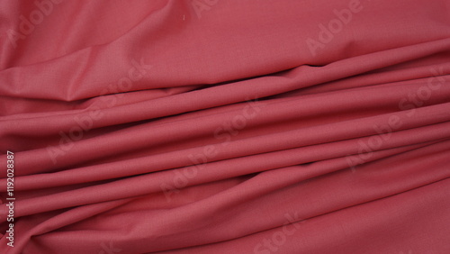 Close-up of rouge pink cotton fabric showing a detailed woven texture, soft natural fibers, and a smooth textile surface perfect for design or background use.