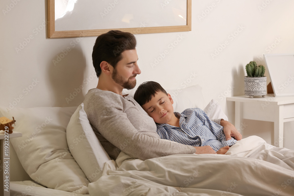 Fototapeta premium Cute little boy with his father sleeping in bedroom