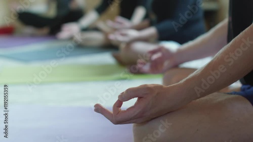 Wallpaper Mural Yoga students are sitting in lotus position on yoga mats, meditating during a group class, performing Gyan mudra hand gesture, with other classmates in soft focus in background Torontodigital.ca