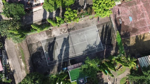 playing tennis in housing cluster in Indonesia photo